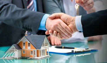 hands shaking over signed paperwork